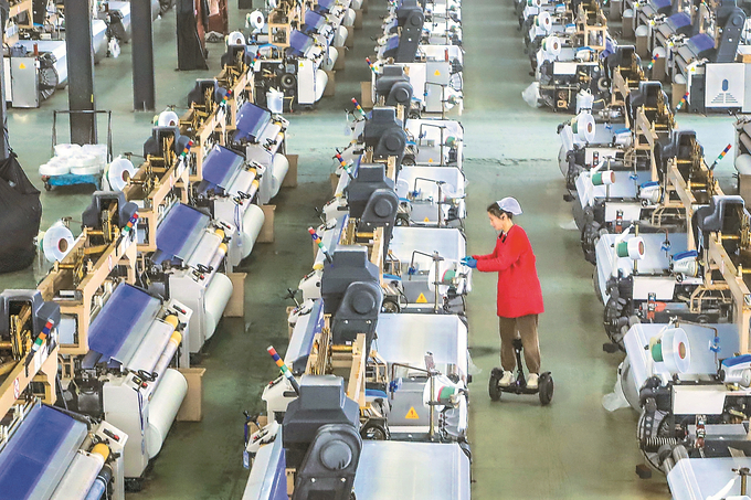 2月28日，东台头灶工业园区，江苏润云纺织的3000台设备正满负荷运转，工人脚踩平衡车在厂区内穿梭忙碌。练益华 摄 （视觉江苏网供图）
